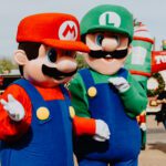 Two people dressed as mario and luigi