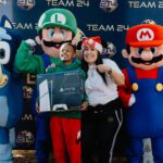 A woman and two men dressed as mario characters