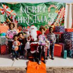 A group of children posing with santa clause.