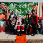 A group of people posing for a picture with santa.