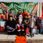 A group of people posing for a picture with santa.