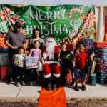 A group of people posing for a picture with santa.