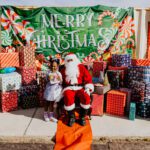 A person in santa suit sitting on the ground