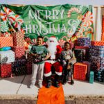 A man and woman posing with santa claus.