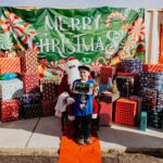 A boy in santa 's costume posing for the camera.