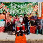 A group of people posing for a picture with santa.