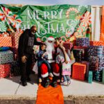 A group of people posing for a picture with santa.