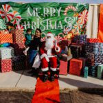 A man sitting on top of santa 's lap.