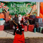 A group of people standing around with presents.