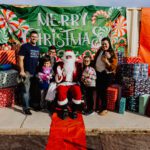 A group of people posing for a picture with santa.