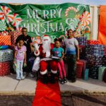 A group of people posing for a picture with santa.