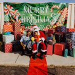 A group of people sitting around with presents.