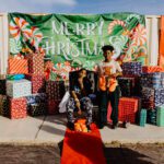 Two people sitting on a bench with many presents