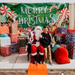 A man sitting on top of santa 's lap.