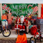 A group of people standing around with santa claus.