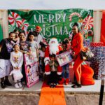 A group of people posing for a picture with santa.