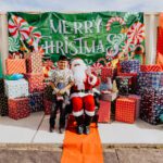 A group of people standing around with presents.