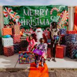 A group of people standing around with presents.