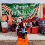 A group of people standing around with presents.