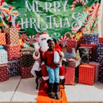 A person sitting in a chair with santa clause