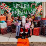 A group of kids posing with santa clause.