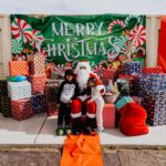 A couple of kids posing for a picture with santa.