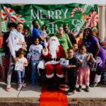 A group of people posing for a picture with santa.