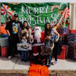 A group of people posing for a picture with santa.