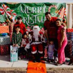 A group of people posing for a picture with santa.