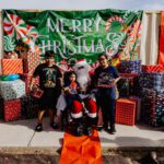 A group of people posing for a picture with santa.