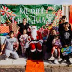 A group of people posing for a picture with santa.