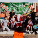 A group of people posing for a picture with santa.