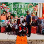 A man and woman posing with santa claus.