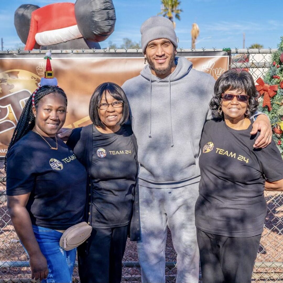 A Man in a Grey Color Hoodie and Pants With Three Women